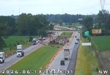 Construction zone with emergency vehicles and equipment on the highway.