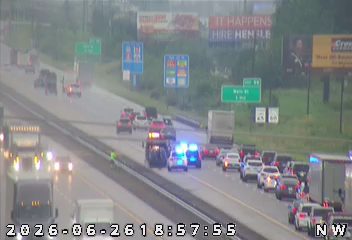 Two police cars with lights on in the left lane