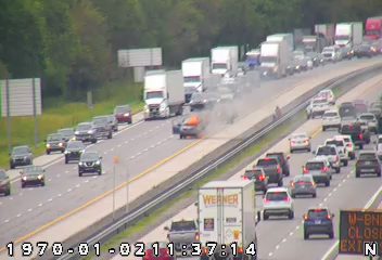 Vehicle fire on the highway causing traffic backup.