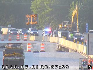 Police car with red and blue lights on the right shoulder
