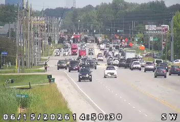 Emergency responders and vehicles are present on the roadway, causing traffic delays.