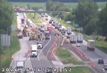 Construction vehicles and cones indicate ongoing road work or an incident response.