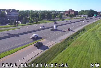 Police car and tow truck on the side of the highway.