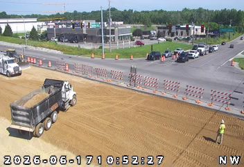 Construction workers and equipment on the roadside, indicating ongoing work.