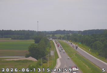 Emergency responders and vehicles are present on the highway, indicating an incident.