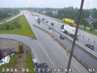 Emergency responders and cones on highway due to ongoing incident.
