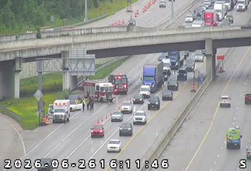 Fire truck and ambulance with emergency lights on the left shoulder