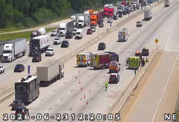 Multiple emergency vehicles and cones in the right lane