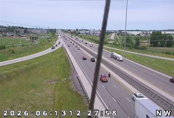 Emergency vehicle and personnel on the shoulder of the highway.