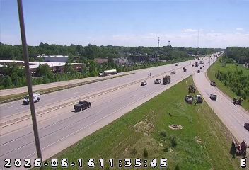 Emergency responders and vehicles are present on the right shoulder of the highway.