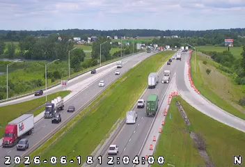 Emergency responders and cones on the right shoulder of the highway.