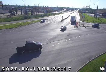 Emergency responders are present at a traffic intersection with cones and personnel.