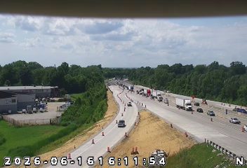 Emergency responders and vehicles are present on the highway, indicating an incident.