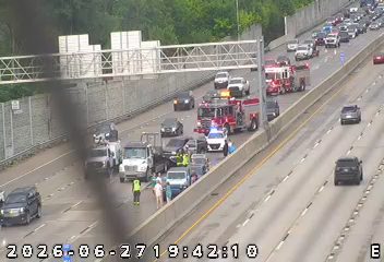 Fire truck and police car with lights on the right shoulder