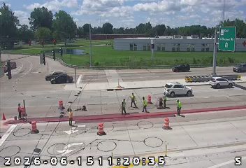 Road work with personnel and equipment present on the roadway.