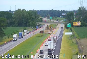 Construction zone with workers and equipment on the highway.