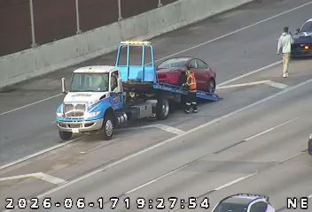 Tow truck and personnel assisting a vehicle on the roadway.