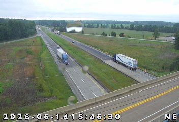 Emergency responder vehicle and personnel on the right shoulder of the highway.