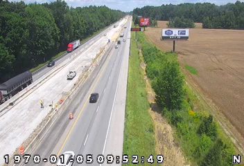 Construction workers and equipment on the highway suggest a work zone incident.