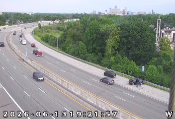 Emergency responders and vehicles are stopped on the shoulder of the highway.