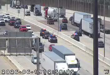 Two police cars with lights on in the right lane