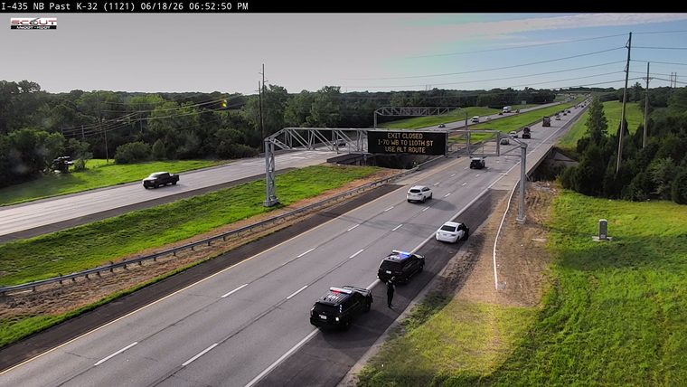 Two police cars with lights on in the right lane