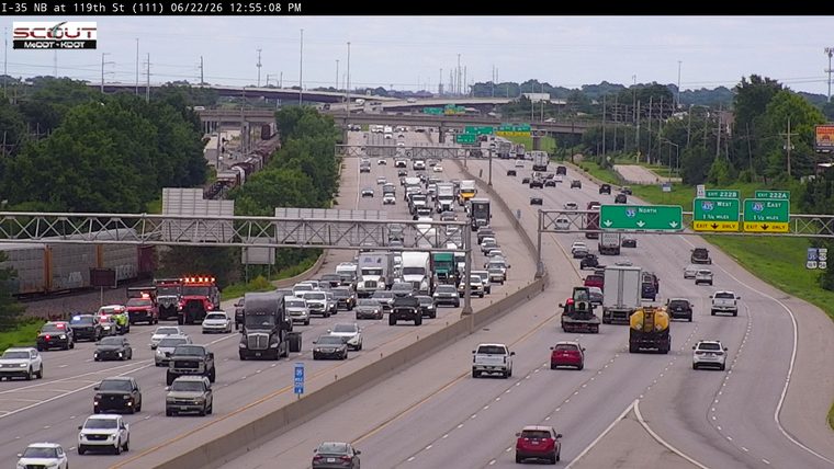 Multiple emergency vehicles with lights on the shoulder