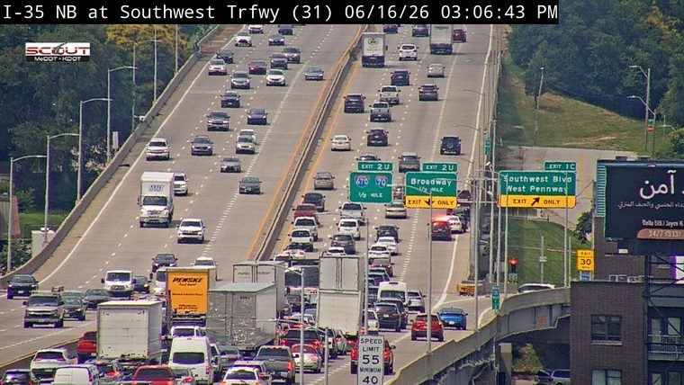 Emergency responders with lights on near the Broadway exit, causing traffic backup.