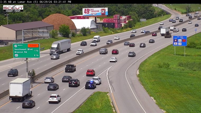 Police car with blue and red lights on the right shoulder