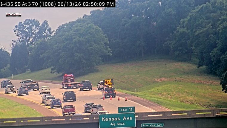 Traffic incident with lane closure and emergency vehicles present.