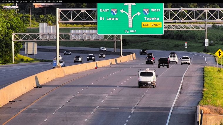 A large piece of debris is lying on the shoulder of the highway.