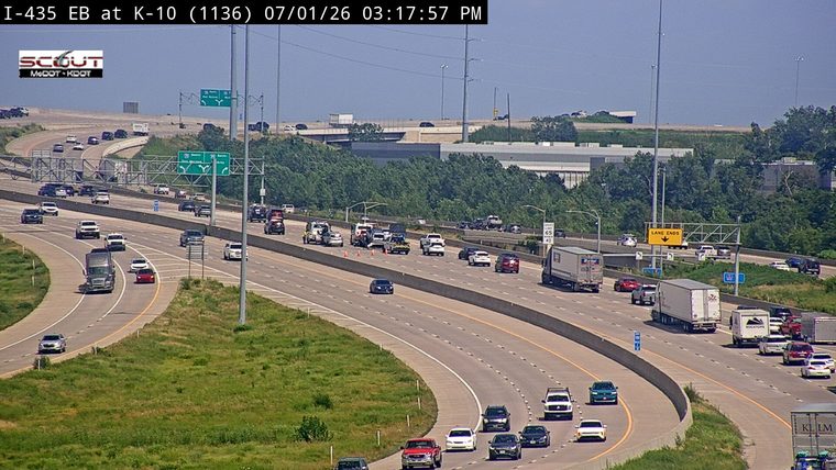 Multiple emergency vehicles and traffic cones in the left lanes