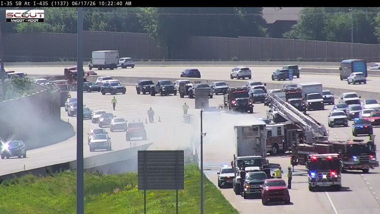 Multiple emergency vehicles and personnel on scene of a traffic incident.
