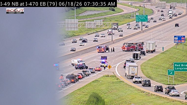 Emergency responders on scene with multiple vehicles including fire trucks and police cars.