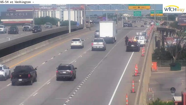 Police car with lights on in the right lane