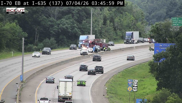 Police car and fire truck with emergency lights on in the right lane