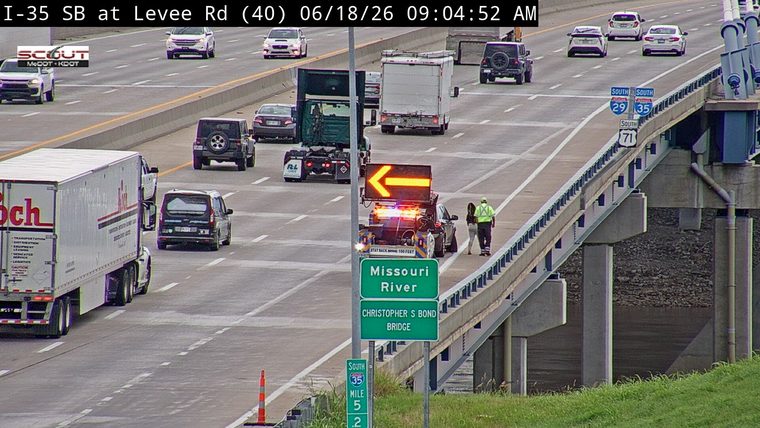 Traffic incident with a tow truck and personnel on the roadway.