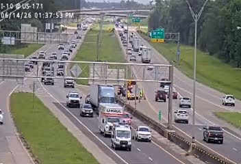Emergency responders and vehicles are present on the highway shoulder.