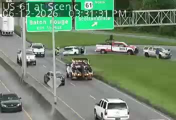 Tow truck and emergency personnel on the side of the road.