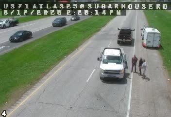 Emergency responders and vehicles are present on the roadside.