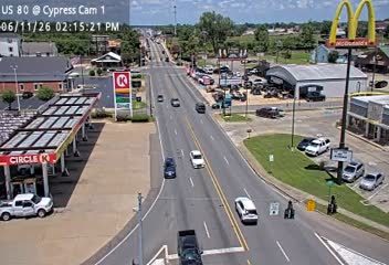 Police and other vehicles are stopped on the side of the road.