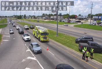 Fire truck and personnel on the side of the highway, traffic is moving slowly.