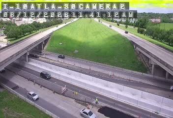 Road work with personnel and equipment visible on the highway shoulder.