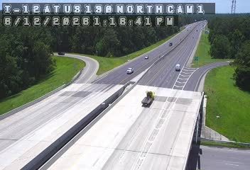 Construction vehicle on overpass, possibly blocking traffic or performing work.