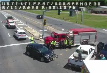 Fire truck and emergency personnel at a multi-vehicle crash scene.