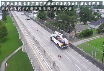 Utility truck and cones on the roadway, possibly responding to an incident.