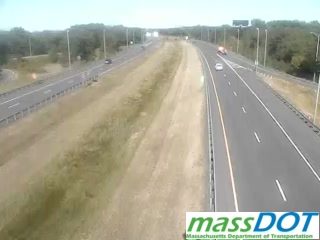 Emergency vehicle on the right shoulder of the highway.