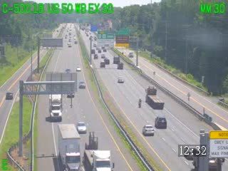 Emergency responders and vehicles on the right shoulder of the highway.