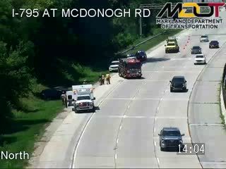Ambulance and fire truck with emergency lights on the right shoulder