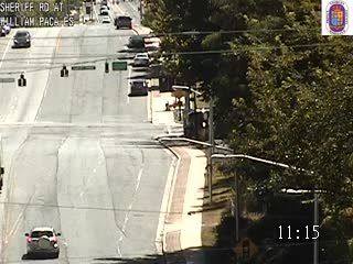 Construction vehicle and workers on the side of the road, possibly responding to an incident.
